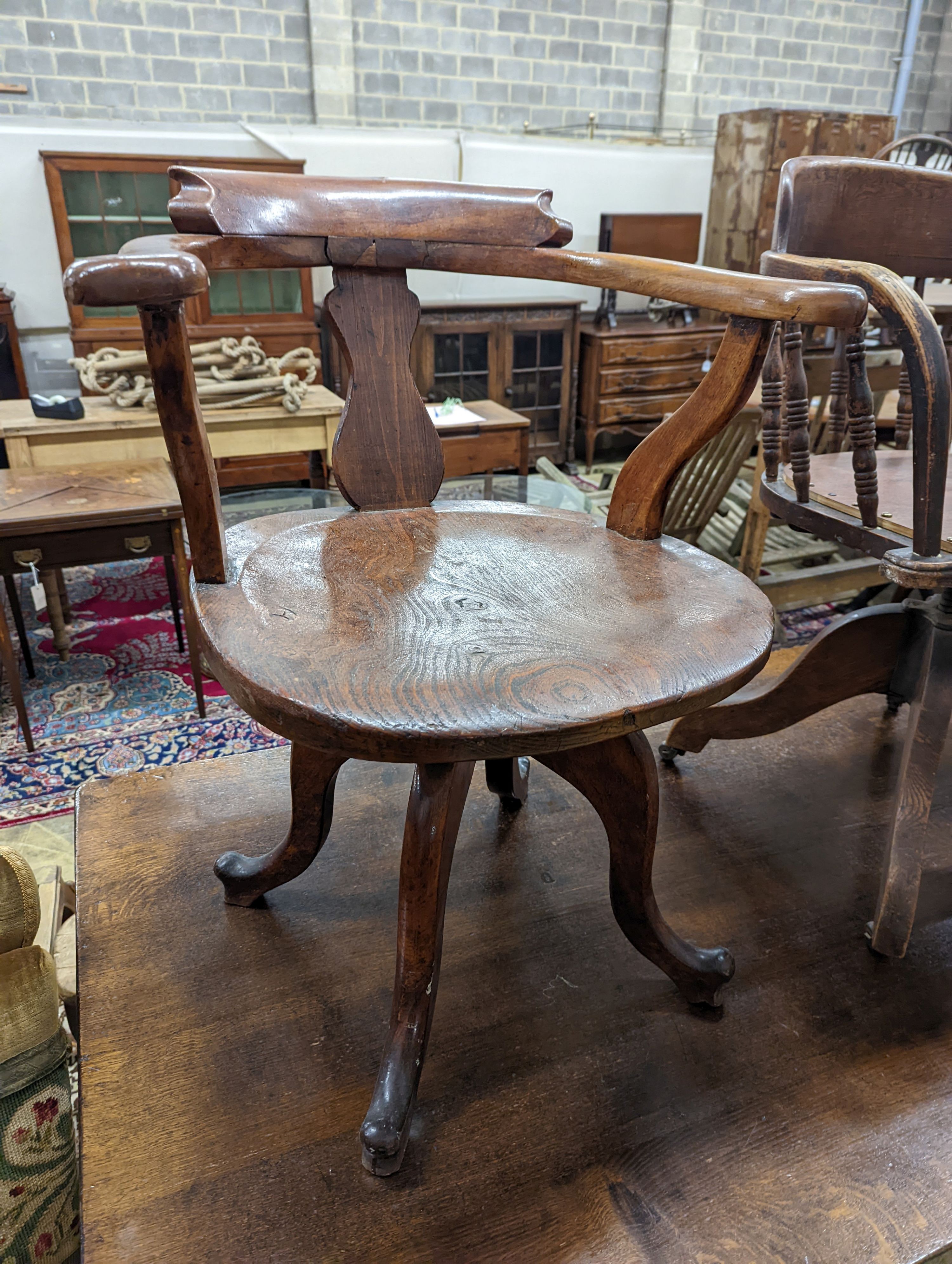 Two early 20th century swivel desk chairs and another chair.